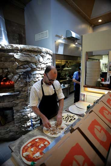 The behemoth, wood-fired, clay-brick pizza oven is the focal point of the Limestone Pizza's open kitchen.